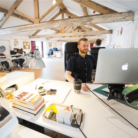 Tabi Group team collaborating in a modern workspace